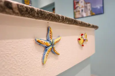a blue and yellow starfish on a wall at Biddizzi Apartment in Palermo