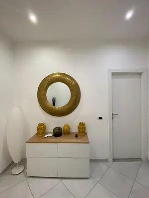 a room with a gold mirror on the wall at Marechiaro Apartments in Palermo