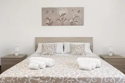 a bedroom with a large bed with two night stands at La Coccinella 