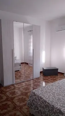 a bedroom with a large glass door with a mirror at La Coccinella 