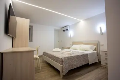a bedroom with a bed and a television in it at Francesco's Home Palermo in Palermo
