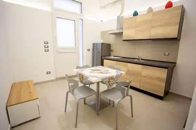a kitchen with a table and chairs in a room at Francesco's Home Palermo in Palermo