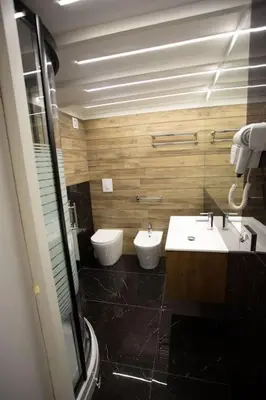 a bathroom with two sinks and two toilets at Francesco's Home Palermo in Palermo