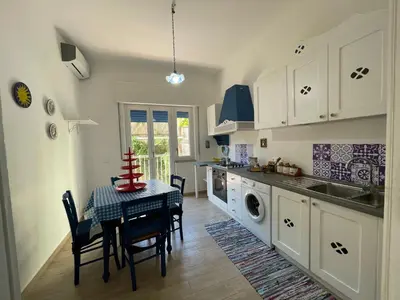 a kitchen with a table and a dining room at Grande Sole Siciliano in Palermo