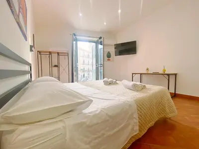 a large white bed in a room with a window at Aliva apartment LT in Palermo