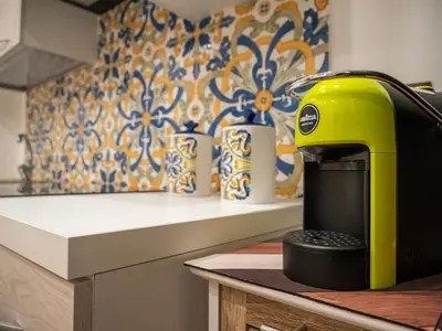 a yellow toaster sitting on top of a kitchen counter at Aliva apartment LT in Palermo