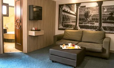 a living room with a couch and a table at Hotel Federico II Central Palace in Palermo