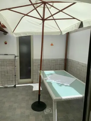an umbrella in a room with a bath tub at Casa Enza Partanna Mondello in Palermo