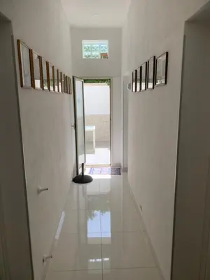 a hallway with white walls and a tile floor at Casa Enza Partanna Mondello in Palermo