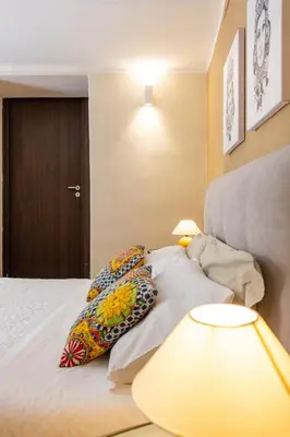 a bedroom with a bed with pillows on it at Casa Carolino in Palermo