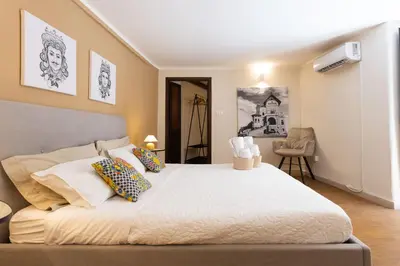 a bedroom with a large white bed with pillows at Casa Carolino in Palermo