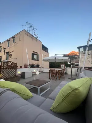 a rooftop patio with a couch and a table at Harin House Casa vacanze in Palermo