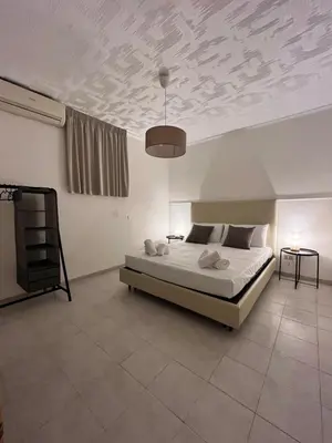 a bedroom with a bed and a coffered ceiling with a bed sqor at Harin House Casa vacanze in Palermo