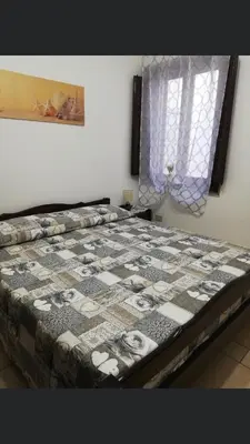 a large bed in a room with a window at Vacanze Da Laura in San Vito lo Capo