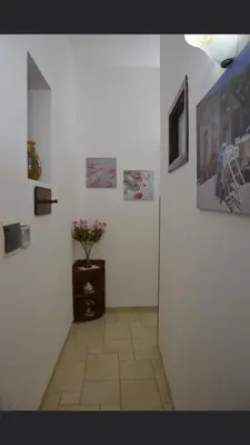 a hallway with a vase of flowers on a wall at Vacanze Da Laura in San Vito lo Capo