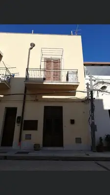 a white building with a balcony and a window at Vacanze Da Laura in San Vito lo Capo