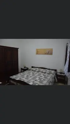 a bedroom with a bed and a painting on the wall at Vacanze Da Laura in San Vito lo Capo