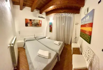 a bedroom with a bed and a table and chairs at Antica Locanda Zio Cesare MONTELEPRE in Montelepre