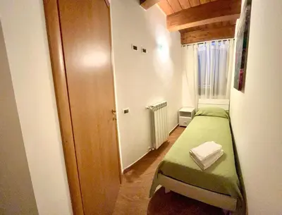 a small room with a green bed and a window at Antica Locanda Zio Cesare MONTELEPRE in Montelepre