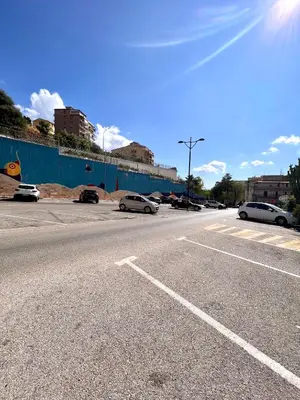 an empty street with cars parked in a parking lot at Antica Locanda Zio Cesare MONTELEPRE in Montelepre
