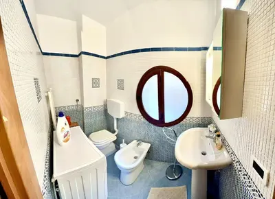 a bathroom with a sink and a toilet and a mirror at Antica Locanda Zio Cesare MONTELEPRE in Montelepre