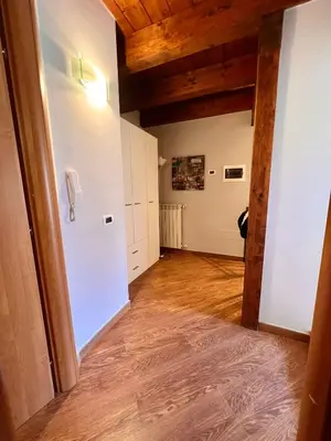 a room with a hallway with wooden ceilings and a room with a phone at Antica Locanda Zio Cesare MONTELEPRE in Montelepre