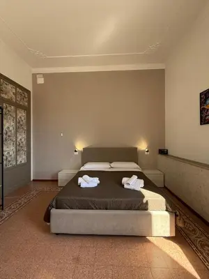 a bedroom with a bed with two towels on it at GUEST HOUSE BOSCO in Palermo