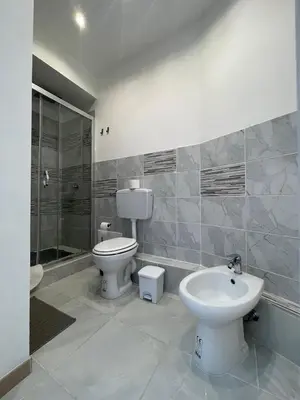 a bathroom with a toilet and a sink at GUEST HOUSE BOSCO in Palermo
