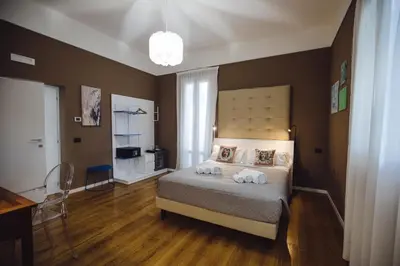 a bedroom with a bed with two towels on it at Villa Calipso in Mondello