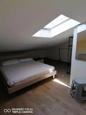 a bedroom with a bed and a skylight at Stella marina in Buonfornello