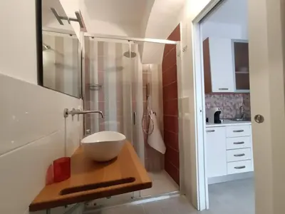 a bathroom with a bowl sink and a shower at Casa vacanze A&G in Castellammare del Golfo
