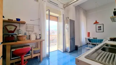 a living room with a couch and a piano at Molo Santa Lucia 248 in Palermo