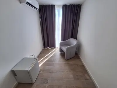a room with a chair and a desk and a window at Domus Levante in Terrasini