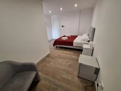 a bedroom with a bed with a red blanket at Domus Levante in Terrasini