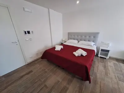 a bedroom with a bed with two towels on it at Domus Levante in Terrasini