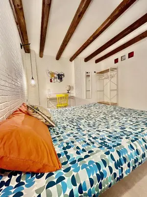 a bedroom with a large bed in a room at Casa Myrtos in Palermo