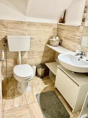 a bathroom with a toilet and a sink at Casa Myrtos in Palermo