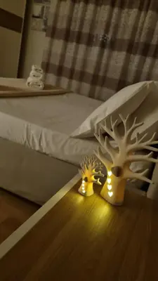 two lights on a table next to a bed at Dudi Apartment in Palermo