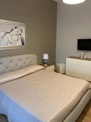 a bedroom with a bed with a picture on the wall at Dudi Apartment in Palermo