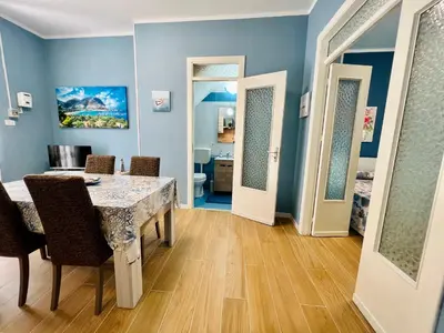 a dining room with blue walls and a table and chairs at Casa del Pescatore in Isola delle Femmine