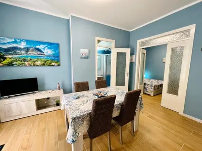 a dining room with a table and a television at Casa del Pescatore in Isola delle Femmine