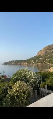 a view of a body of water with mountains in the background at Covo del pescatore in Bagheria