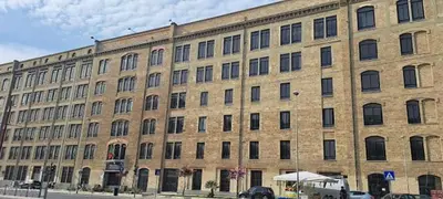 a large brick building with a lot of windows at Maya's Apartment close to Ballarò Market and Central station in Palermo
