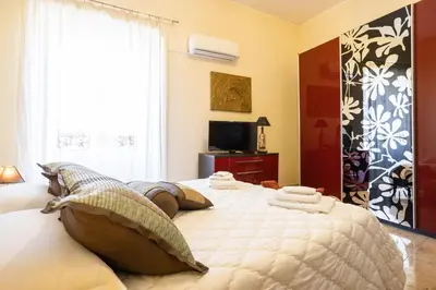 a bedroom with a large bed with pillows on it at Hola Cathedral House Porta di Castro in Palermo