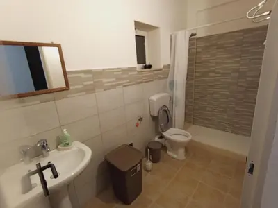 a bathroom with a sink and a toilet at MC Rooms in Torretta