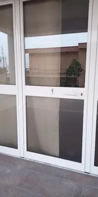 a glass door of a building with a balcony at MC Rooms in Torretta