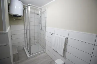a bathroom with a shower with a glass door at Casa chrilù in Palermo