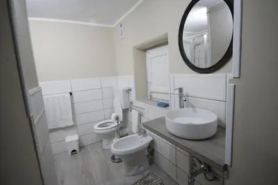 a bathroom with a sink and a toilet and a mirror at Casa chrilù in Palermo