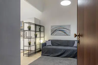 a living room with a couch and a window at Al Khalisa Apartment by Wonderful Italy in Palermo