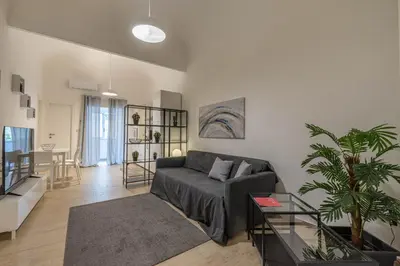 a living room with a couch and a table at Al Khalisa Apartment by Wonderful Italy in Palermo